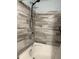 Bathroom with tiled shower walls, black shower head, and white tub at 8360 S Evening Dr, Pendleton, IN 46064