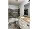 Bathroom with a granite-topped vanity, modern tiling, and a shower-tub combo, offering both style and functionality at 8360 S Evening Dr, Pendleton, IN 46064