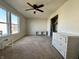 Bedroom featuring a ceiling fan, carpet flooring, multiple windows, and a white cabinet at 8360 S Evening Dr, Pendleton, IN 46064