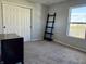 Bedroom with neutral carpet, bright natural light from the window, and a large closet with white folding doors at 8360 S Evening Dr, Pendleton, IN 46064
