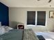 Cozy bedroom featuring ample sunlight, window blinds and a dark blue accent wall at 8360 S Evening Dr, Pendleton, IN 46064