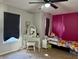 Bedroom with desk and trundle bed, large windows, and ceiling fan at 8360 S Evening Dr, Pendleton, IN 46064