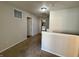 A well-lit hallway with neutral carpeting, showcasing access to different rooms and areas of the home at 8360 S Evening Dr, Pendleton, IN 46064