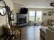 Living room with fireplace, TV and lots of natural sunlight from large windows at 8360 S Evening Dr, Pendleton, IN 46064
