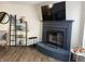 Living room featuring a dark brick fireplace, wood floors, and decorative shelves at 8360 S Evening Dr, Pendleton, IN 46064