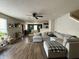 Comfortable living room with a large sectional sofa, wood floors, and a ceiling fan at 8360 S Evening Dr, Pendleton, IN 46064