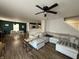 Bright living room featuring a large sectional sofa, dining area, and an open floor plan at 8360 S Evening Dr, Pendleton, IN 46064
