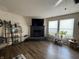 Bright living room featuring a brick fireplace and large, light-filled windows at 8360 S Evening Dr, Pendleton, IN 46064