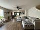 Comfortable living room with a large sectional sofa, wood floors, and a ceiling fan at 8360 S Evening Dr, Pendleton, IN 46064