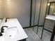 Bathroom featuring dual sink vanity, gray walls, and closet with mirror doors at 8940 Black Hawk Ln, Indianapolis, IN 46234