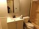 Cozy bathroom featuring a white vanity, toilet, and shower with peach colored walls at 8940 Black Hawk Ln, Indianapolis, IN 46234