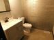 Modern bathroom with tiled wall, stylish vanity, and contemporary fixtures at 8940 Black Hawk Ln, Indianapolis, IN 46234