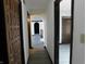 A hallway featuring dark stained doors and trim that lead to other rooms in the home at 8940 Black Hawk Ln, Indianapolis, IN 46234