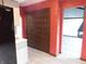 Hallway features textured red walls, and a storage closet with intricately designed bi-fold doors at 8940 Black Hawk Ln, Indianapolis, IN 46234