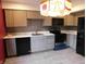 Charming kitchen with modern appliances, tile backsplash, and a unique stained glass light fixture at 8940 Black Hawk Ln, Indianapolis, IN 46234