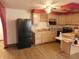 Well-lit kitchen featuring ample cabinet space, newer appliances and laminate flooring at 8940 Black Hawk Ln, Indianapolis, IN 46234