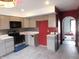 Spacious kitchen featuring ample cabinet space and open archway into the next room at 8940 Black Hawk Ln, Indianapolis, IN 46234