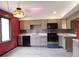 Modern kitchen with stainless steel appliances, gray cabinets, and a skylight at 8940 Black Hawk Ln, Indianapolis, IN 46234
