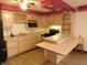 Kitchen area with wood cabinets, breakfast bar, and modern appliances at 8940 Black Hawk Ln, Indianapolis, IN 46234