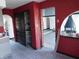 Living room featuring archways, an ornate fireplace, striking red walls, and closet at 8940 Black Hawk Ln, Indianapolis, IN 46234