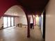 Open concept living area with pink arches, neutral walls, and laminate wood flooring at 8940 Black Hawk Ln, Indianapolis, IN 46234