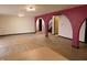 Living room featuring red architectural arches, white walls, and light wood-look flooring at 8940 Black Hawk Ln, Indianapolis, IN 46234