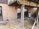 View of the patio and brick exterior with sliding glass doors and a water filtration system at 8940 Black Hawk Ln, Indianapolis, IN 46234