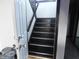 An interior staircase with dark wood and an adjacent doorway enhance the entryway's appeal at 8940 Black Hawk Ln, Indianapolis, IN 46234