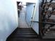 View down the interior staircase, featuring white walls and dark banisters at 8940 Black Hawk Ln, Indianapolis, IN 46234