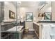Elegant bathroom with a glass-enclosed shower, soaking tub, and double vanity with dark cabinets at 932 N Broadway St # 1, Indianapolis, IN 46202