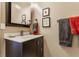 Modern bathroom with dark vanity and decorative mirror at 932 N Broadway St # 1, Indianapolis, IN 46202