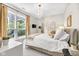 Cozy bedroom with a large window, plush bedding, and stylish decor at 932 N Broadway St # 1, Indianapolis, IN 46202