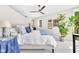 Bright bedroom with a ceiling fan, decorative pillows, and a large plant at 932 N Broadway St # 1, Indianapolis, IN 46202
