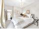 Bright bedroom featuring a large mirror, chandelier, and decorative accents at 932 N Broadway St # 1, Indianapolis, IN 46202