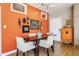 Dining room with orange accent wall and natural light at 932 N Broadway St # 1, Indianapolis, IN 46202