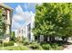Modern townhome exterior with a landscaped yard, large windows, and contemporary design at 932 N Broadway St # 1, Indianapolis, IN 46202