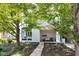 Modern townhome with a manicured front yard, featuring a gray brick facade and inviting covered porch at 932 N Broadway St # 1, Indianapolis, IN 46202