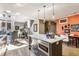 Open-concept kitchen with stainless steel appliances and views of the dining and living areas at 932 N Broadway St # 1, Indianapolis, IN 46202
