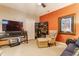 Cozy bonus room with accent wall, TV, and sitting area at 932 N Broadway St # 1, Indianapolis, IN 46202