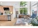 Open-concept space boasting oversized windows, a leather sofa, and seamless flow from the adjacent kitchen at 932 N Broadway St # 1, Indianapolis, IN 46202