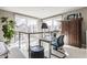 Bright office space features a desk, modern chair, and natural light from the large windows, perfect for a home workspace at 932 N Broadway St # 1, Indianapolis, IN 46202