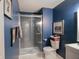 Stylish bathroom featuring a glass-enclosed shower and modern fixtures against blue walls at 9505 Bay Vista W Dr, Indianapolis, IN 46250