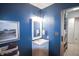 Bathroom featuring a white vanity and stylish fixtures, alongside a laundry area at 9505 Bay Vista W Dr, Indianapolis, IN 46250