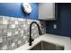 Close up on kitchen sink area featuring quartz countertops and decorative tiled backsplash at 9505 Bay Vista W Dr, Indianapolis, IN 46250