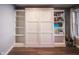 Cozy living area featuring a Murphy bed flanked by built-in shelving for organized living at 9505 Bay Vista W Dr, Indianapolis, IN 46250