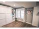 Murphy bed and built-in shelving in living area with wood-look flooring and natural light at 9505 Bay Vista W Dr, Indianapolis, IN 46250