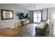 Bright living room with vaulted ceiling, modern furniture, a large window and plank flooring at 9505 Bay Vista W Dr, Indianapolis, IN 46250