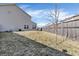 Backyard features a wood fence, green space, a sapling, and the siding of the house at 10326 Haag Dr, Brownsburg, IN 46112