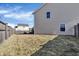 View of the large backyard, featuring a wood fence, green space, and the siding of the house at 10326 Haag Dr, Brownsburg, IN 46112