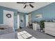 Blue bedroom featuring a white desk area, cozy bed, and plenty of storage at 10326 Haag Dr, Brownsburg, IN 46112